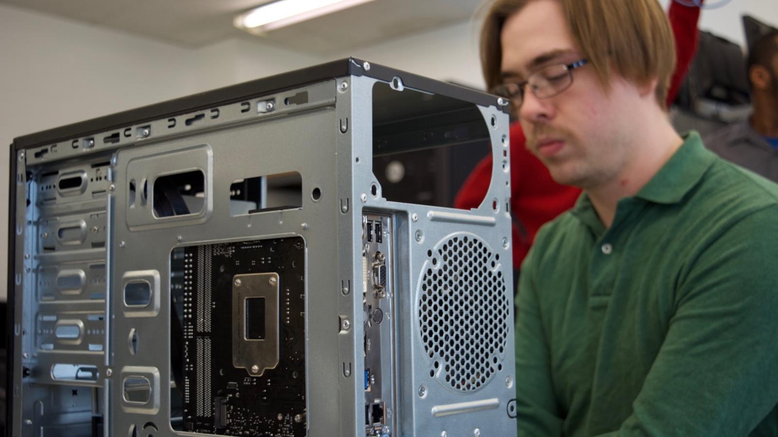 A computer networking & security student troubleshoots a desktop system 
