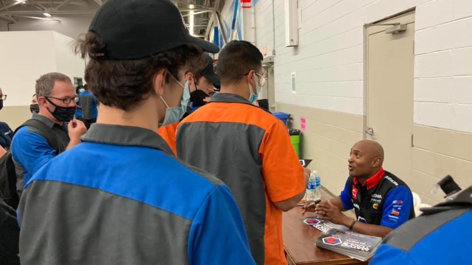Antron Brown signs autographs for students