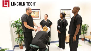 Students learn massage therapy techniques from a Lincoln Tech instructor 