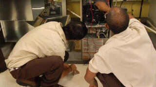 HVAC Students in our Denver campus working on a commercial HVAC system