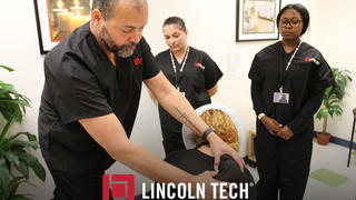 A Lincoln Tech Massage Therapy student practices newly-learned massage techniques