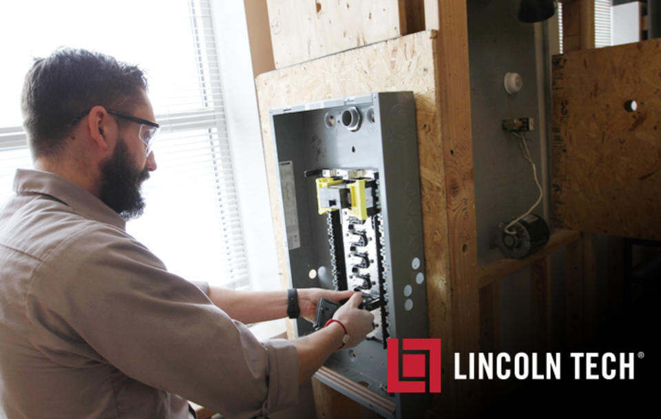 A Lincoln Tech Electrical Program Student works on building a circuit breaker box