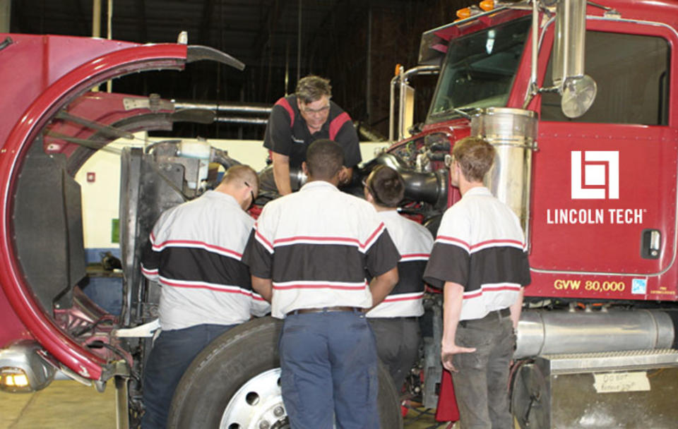 A diesel instructor teaches a group of student technicians proper diesel engine diagnosis