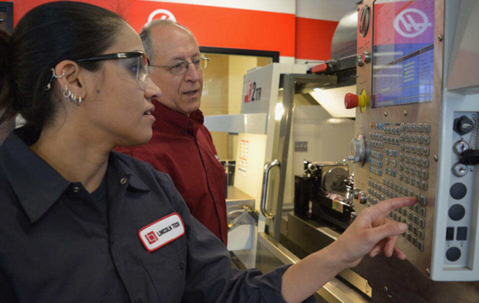 A Female CNC Student learns how to operate a Haas CNC Machine